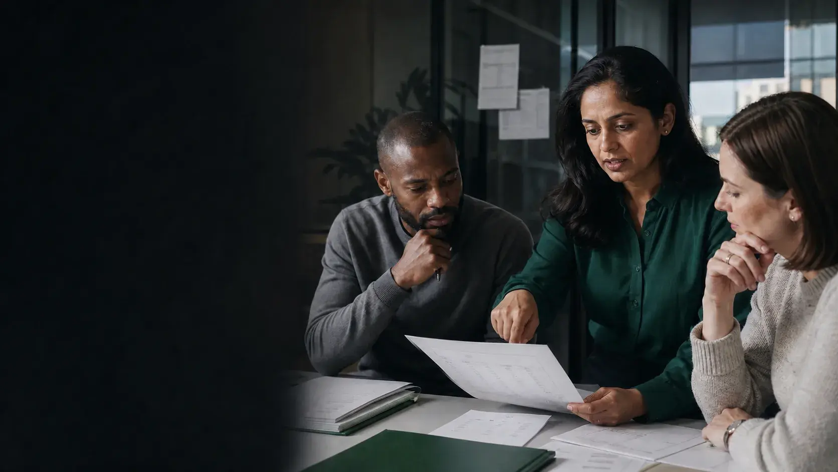 A finance operations leader and colleagues reviewing billing details together